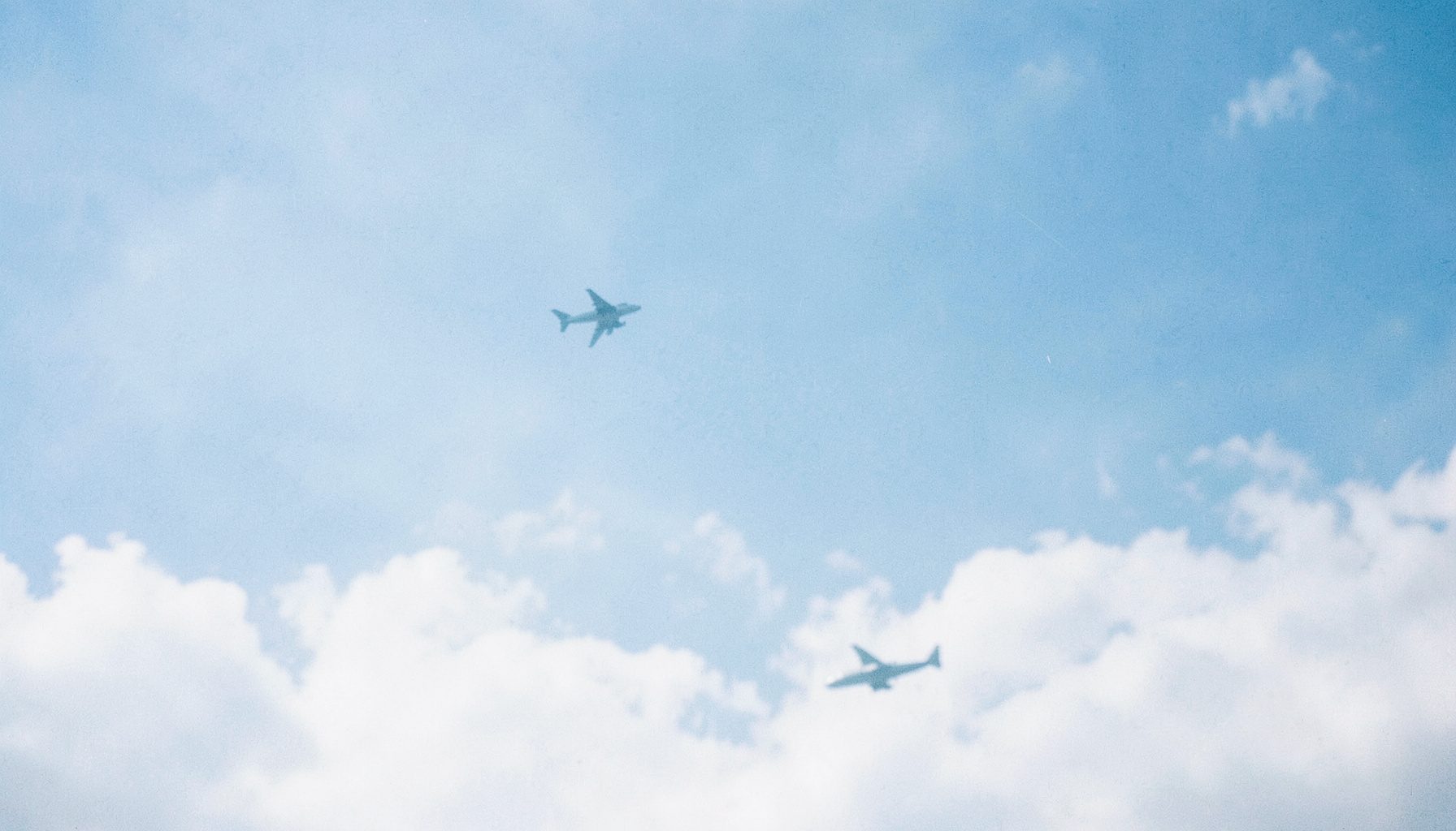 Soft blue gradient with a faint aircraft silhouette drifting through light clouds, conveying a calm and secure atmosphere